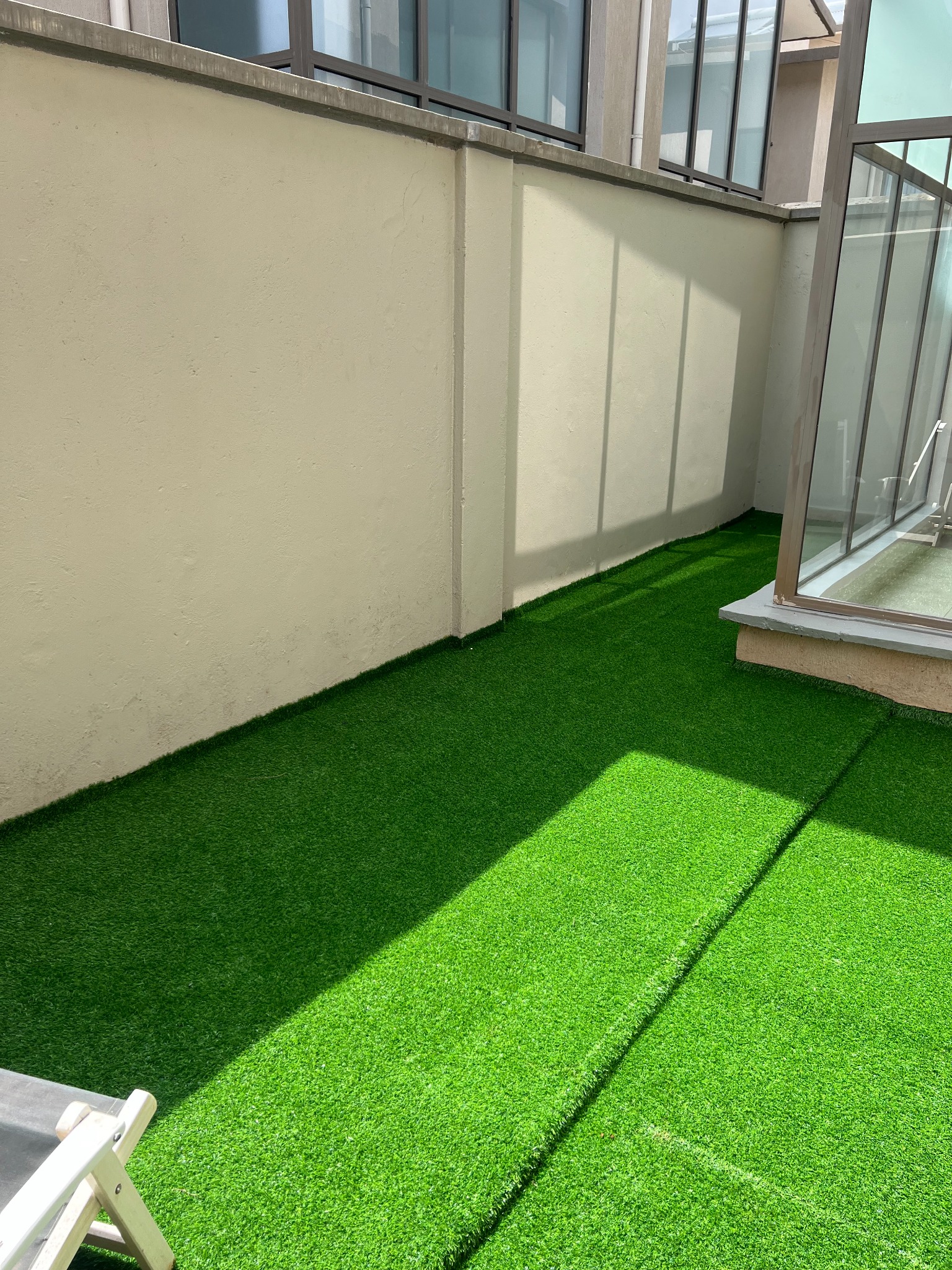Narrow courtyard before artificial grass