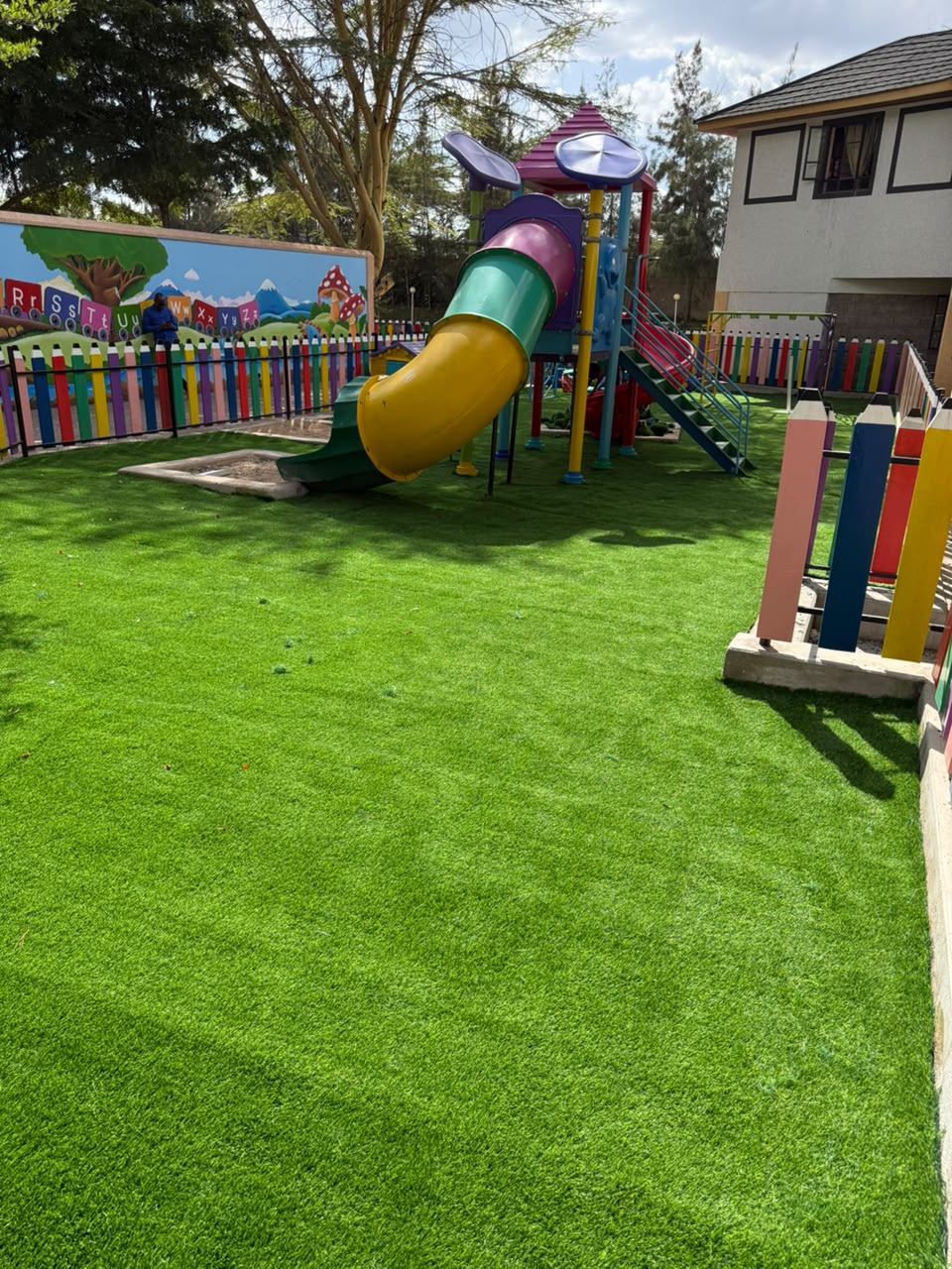 Artificial grass installed around a school playground